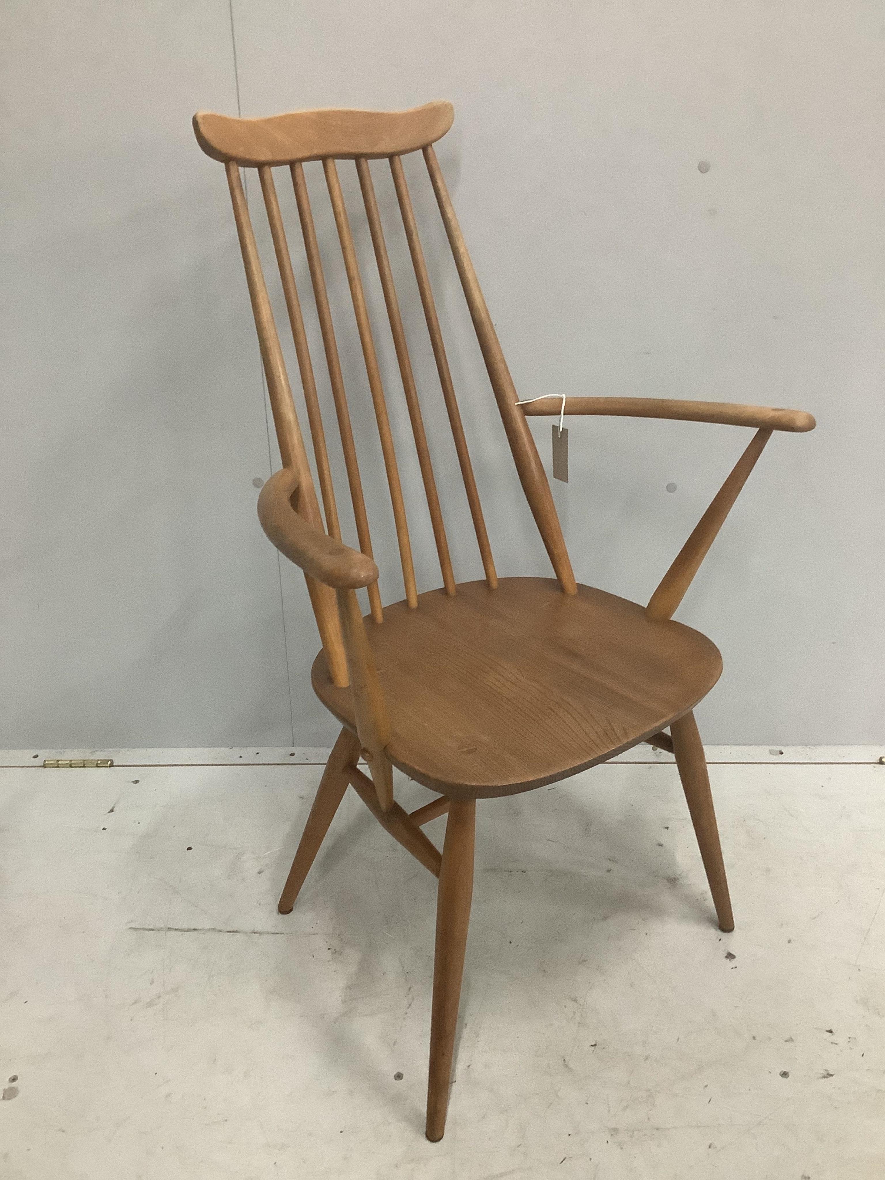 An Ercol Goldsmith's comb back elbow chair, width 61cm, depth 41cm, height 98cm. Condition - fair